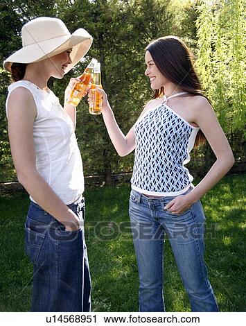 Two women drinking beer View Large Photo Image Stock Image - Two women drinking beer. Fotosearch