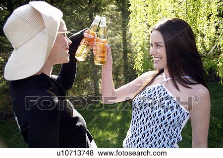 Two women drinking beer View Large Photo Image Stock Photo - Two women drinking beer. Fotosearch