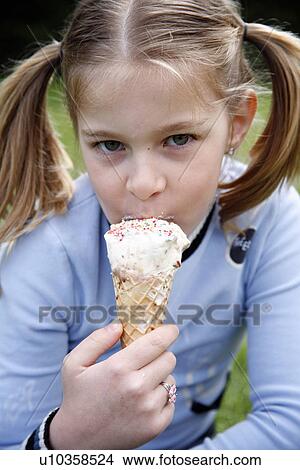 Young girl eating ice cream View Large Photo Image Picture - Young girl eating ice cream . Fotosearch