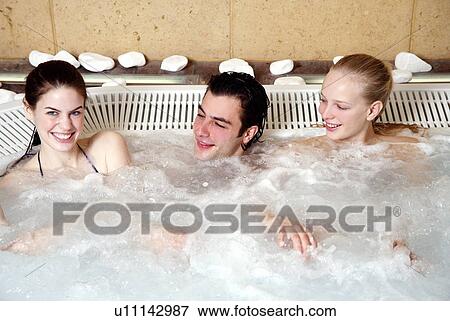 One man with two women in jacuzzi at a spa View Large Photo Image Stock Photo - One man with two women in jacuzzi at a spa. Fotosearch