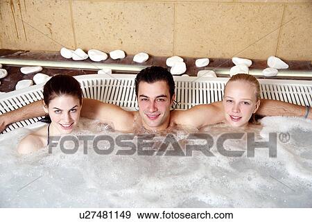One man with two women in jacuzzi at a spa View Large Photo Image Stock Photo - One man with two women in jacuzzi at a spa. Fotosearch
