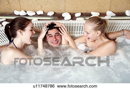 One man with two women in jacuzzi at a spa View Large Photo Image Stock Photograph - One man with two women in jacuzzi at a spa. Fotosearch