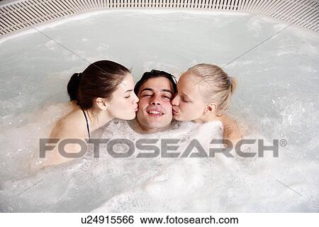 One man with two women in jacuzzi at a spa View Large Photo Image Stock Photograph - One man with two women in jacuzzi at a spa. Fotosearch