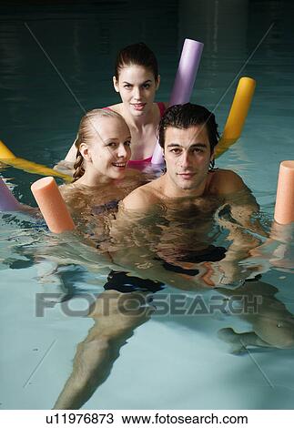 Stock Image - People exercising in a spa pool. Fotosearch