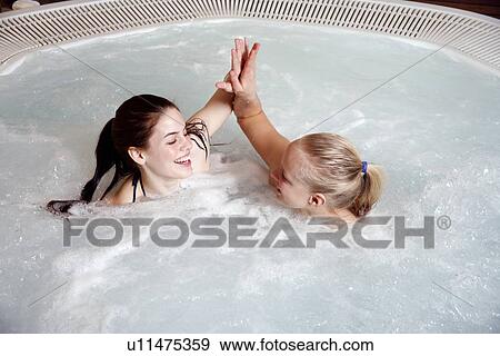 Two young women in jacuzzi at a spa View Large Photo Image Stock Photo - Two young women in jacuzzi at a spa. Fotosearch