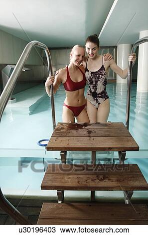 Two young women standing next to spa pool View Large Photo Image Stock Image - Two young women standing next to spa pool. Fotosearch