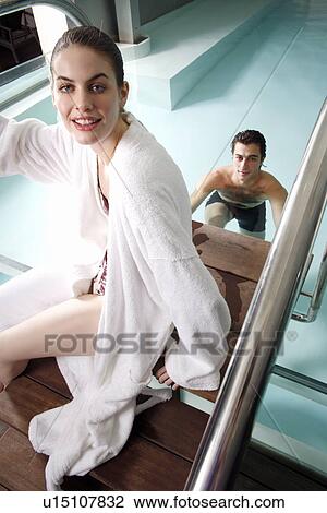 Stock Image - Young couple in a swimming pool at a spa. Fotosearch