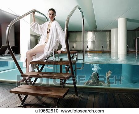 Stock Image - Young couple in a swimming pool at a spa. Fotosearch