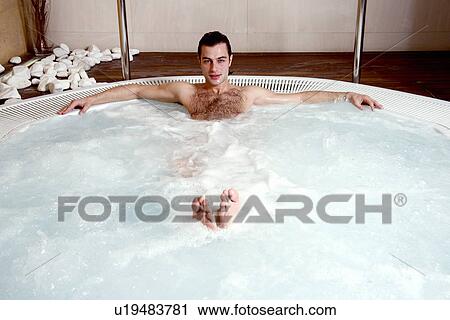 Young man in jacuzzi at a spa View Large Photo Image Stock Image - Young man in jacuzzi at a spa. Fotosearch