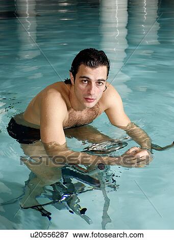 Young man on exercise bike in spa pool View Large Photo Image Stock Photo - Young man on exercise bike in spa pool. Fotosearch