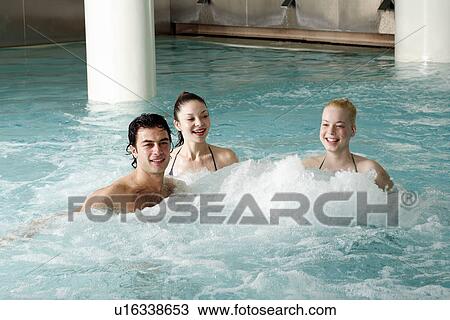 Young people swimming in spa pool View Large Photo Image Stock Image - Young people swimming in spa pool. Fotosearch