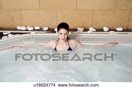 Picture - Young woman in jacuzzi at a spa. Fotosearch