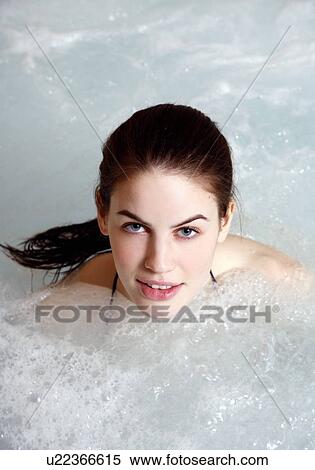 Stock Photography - Young woman in jacuzzi at a spa. Fotosearch