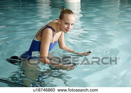 Young woman on exercise bike in spa pool View Large Photo Image Stock Image - Young woman on exercise bike in spa pool. Fotosearch