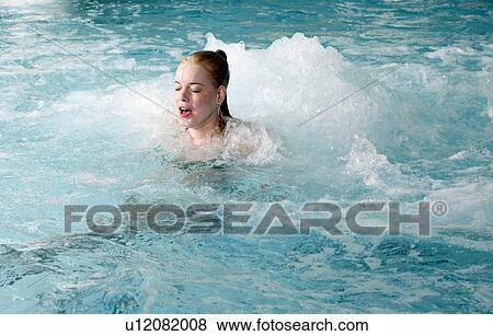 Young woman swimming in spa pool View Large Photo Image Stock Photo - Young woman swimming in spa pool. Fotosearch