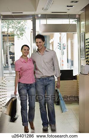 Couple entering sunglasses store View Large Photo Image Stock Photograph - Couple entering sunglasses store. Fotosearch