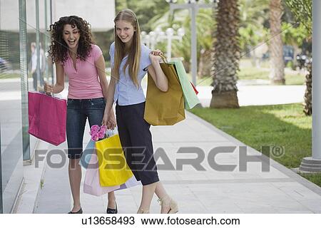 Two women with shopping bags View Large Photo Image Stock Image - Two women with shopping bags. Fotosearch