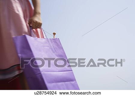 Woman's hand holding shopping bag View Large Photo Image Picture - Woman's hand holding shopping bag. Fotosearch