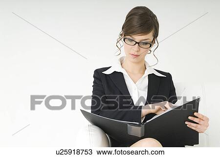 Businesswoman looking at file View Large Photo Image Stock Image - Businesswoman looking at file. Fotosearch
