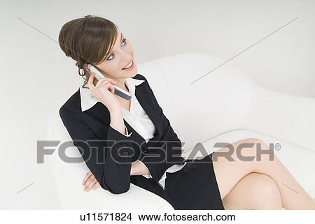 Businesswoman talking over cell phone View Large Photo Image Picture - Businesswoman talking over cell phone. Fotosearch