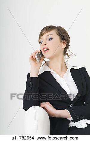 Businesswoman talking over cell phone View Large Photo Image Picture - Businesswoman talking over cell phone. Fotosearch