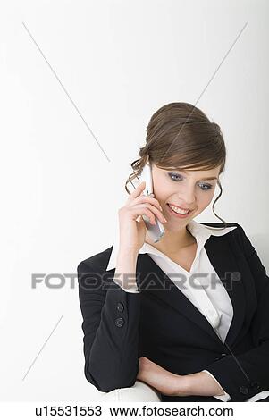 Businesswoman talking over cell phone View Large Photo Image Stock Image - Businesswoman talking over cell phone. Fotosearch