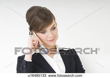 Stock Image - Businesswoman talking over cell phone. Fotosearch