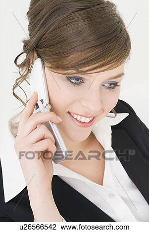 Businesswoman talking over cell phone View Large Photo Image Stock Image - Businesswoman talking over cell phone. Fotosearch