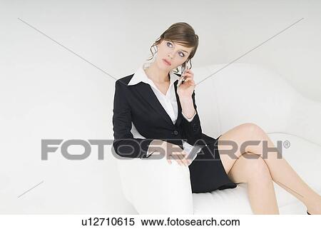 Businesswoman talking over cell phone View Large Photo Image Stock Photography - Businesswoman talking over cell phone. Fotosearch