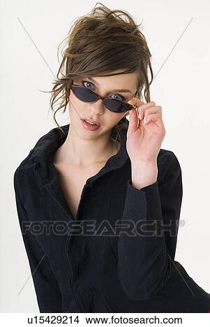 Picture - Portrait of young woman wearing sunglasses. Fotosearch
