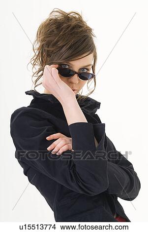 Portrait of young woman wearing sunglasses View Large Photo Image Picture - Portrait of young woman wearing sunglasses. Fotosearch