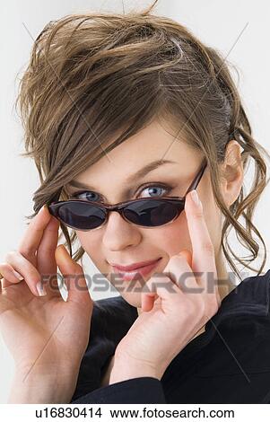 Picture - Portrait of young woman wearing sunglasses. Fotosearch