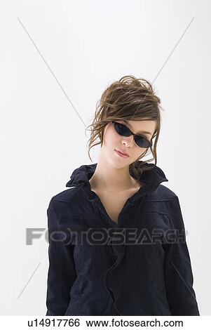 Portrait of young woman wearing sunglasses View Large Photo Image Stock Photograph - Portrait of young woman wearing sunglasses. Fotosearch