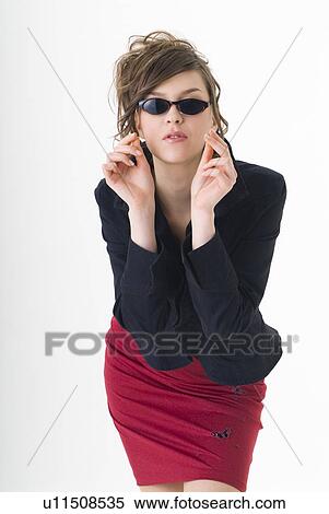 Portrait of young woman wearing sunglasses View Large Photo Image Stock Photography - Portrait of young woman wearing sunglasses. Fotosearch