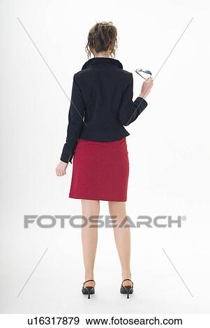 Rear view of young woman standing View Large Photo Image Stock Photo - Rear view of young woman standing. Fotosearch