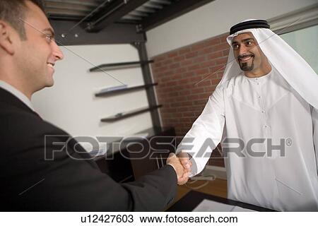 Stock Image - business, handshake, shake, hand, Arabic. Fotosearch