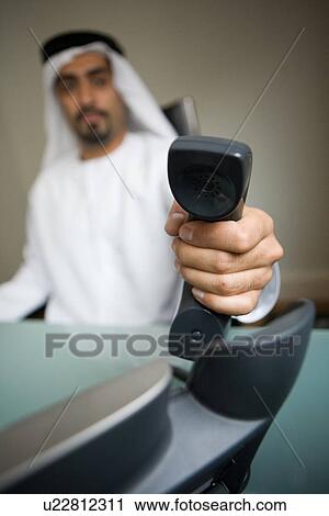 Stock Image - business, phone, businessmen, businessman, Arabic. Fotosearch