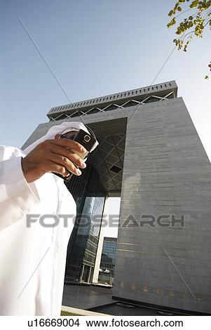 dishdash, businessman, shumagh, tower, business, trade, arabic View Large Photo Image Picture - dishdash, businessman, shumagh, tower, business, trade, arabic. Fotosearch