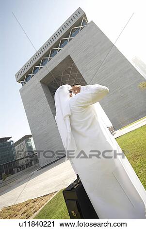 Stock Image - dishdash, businessman, shumagh, tower, business, trade, arabic. Fotosearch