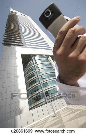 Stock Photo - dishdash, businessman, shumagh, tower, business, trade, arabic. Fotosearch