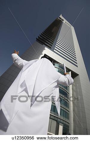Stock Photograph - dishdash, businessman, shumagh, tower, business, trade, arabic. Fotosearch
