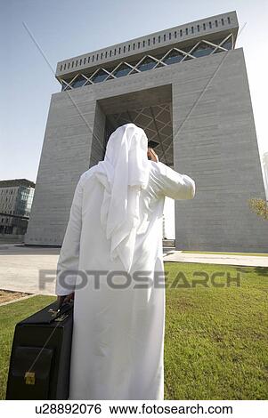 Stock Photograph - dishdash, businessman, shumagh, tower, business, trade, arabic. Fotosearch