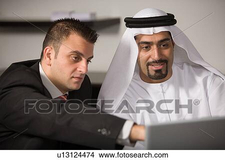 Picture - laptop, business, computer, businessmen, businessman, Arabic. Fotosearch