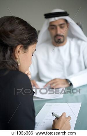 Stock Photograph - signing, business, woman, businessmen, businessman, Arabic. Fotosearch