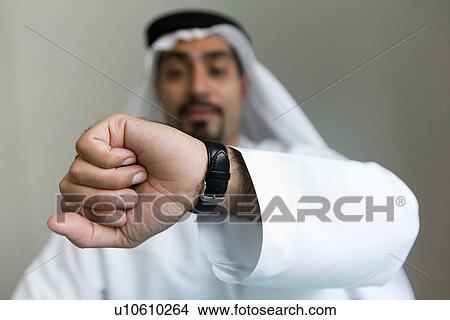 Picture - time, business, watch, businessmen, businessman, Arabic. Fotosearch