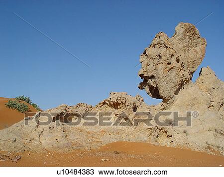 Stock Image - desert, rock, heat, sand, bleu, clear, sky. Fotosearch