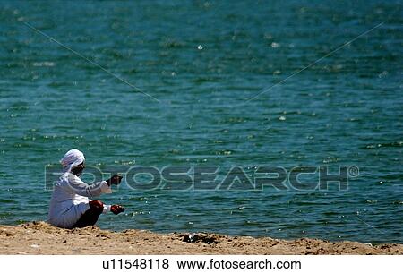 Stock Photo - buing, birds, lifestyle, child, arab. Fotosearch