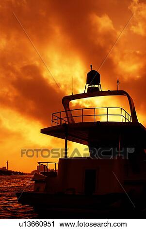 Stock Image - silhouette, boat, art, artistic, sunset, sunrise, colourful. Fotosearch