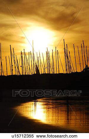 Stock Photography - sunset, sun, rise, sunrise, port, boats, gold. Fotosearch