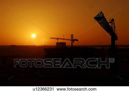 Stock Image - sunset, sunrise, rise, dubai, work, construction, building. Fotosearch